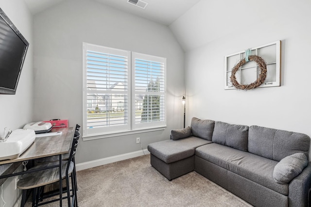 carpeted living area with lofted ceiling, visible vents, and baseboards