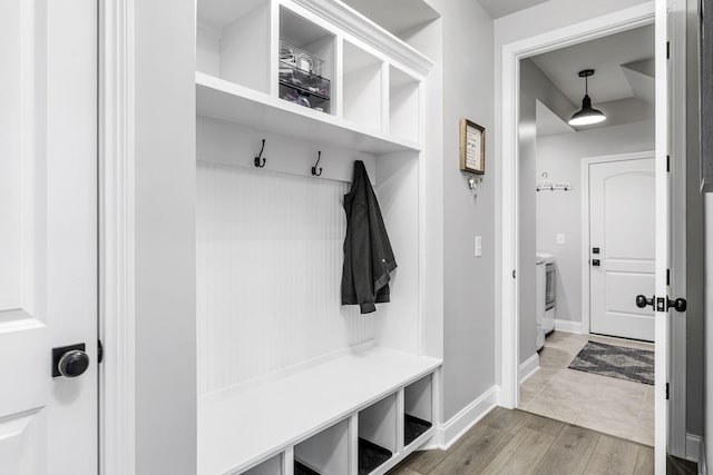 mudroom featuring baseboards and wood finished floors