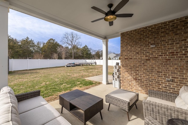 view of patio featuring a fenced backyard, an outdoor living space, and a ceiling fan