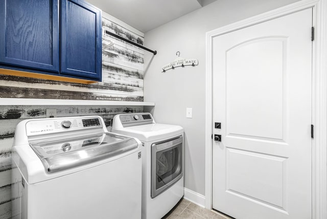 laundry room featuring baseboards, cabinet space, and washer and dryer