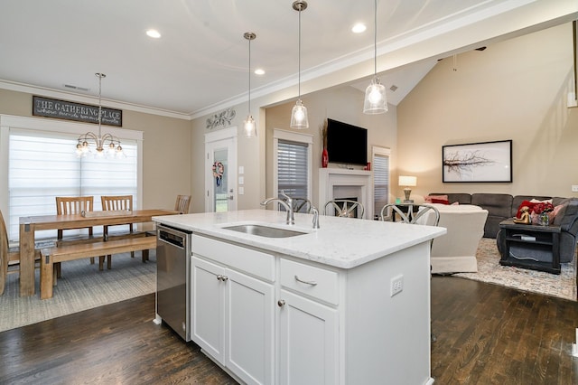 kitchen featuring lofted ceiling, ornamental molding, open floor plan, a sink, and stainless steel dishwasher