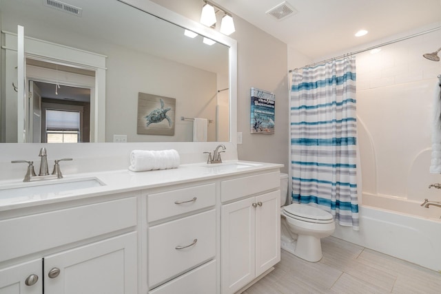 full bathroom with toilet, a sink, and visible vents