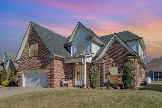 traditional-style house featuring an attached garage, brick siding, a shingled roof, driveway, and a front yard