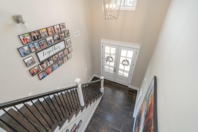 entrance foyer with french doors, wood finished floors, a wealth of natural light, and baseboards