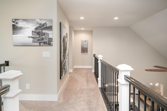 corridor featuring baseboards, carpet flooring, an upstairs landing, and recessed lighting