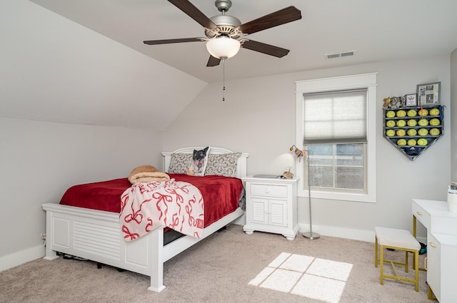 carpeted bedroom with vaulted ceiling, ceiling fan, visible vents, and baseboards