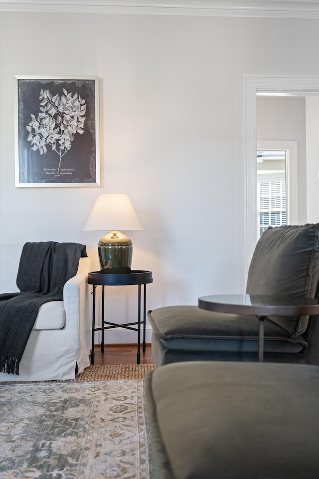 living room with crown molding and wood finished floors