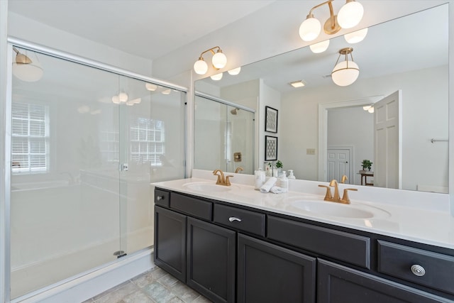 full bathroom featuring a stall shower, a sink, and double vanity