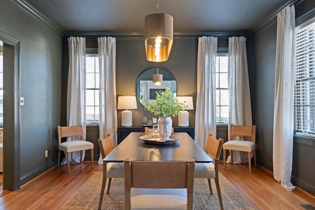 dining area featuring visible vents, a wealth of natural light, and wood finished floors