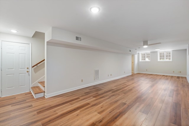 basement with stairway, visible vents, and light wood-style flooring