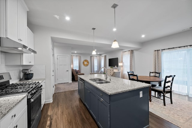 kitchen featuring visible vents, appliances with stainless steel finishes, dark wood-type flooring, a sink, and under cabinet range hood