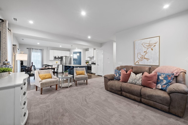 living room featuring visible vents and recessed lighting