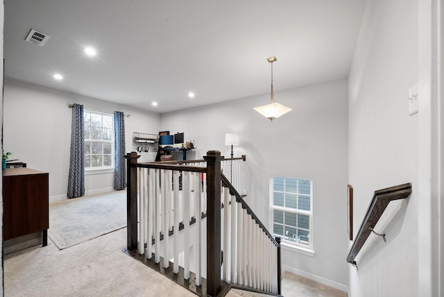 stairs with carpet floors, recessed lighting, visible vents, and baseboards