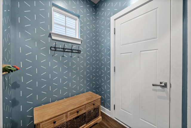 mudroom featuring wallpapered walls, baseboards, and dark wood finished floors