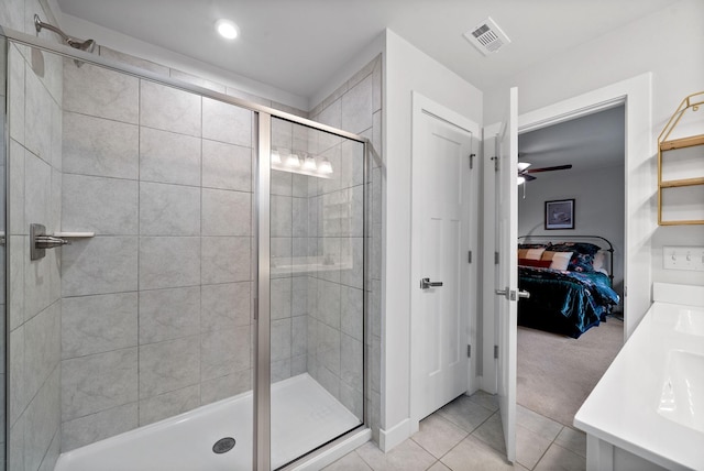 ensuite bathroom with visible vents, ensuite bathroom, a stall shower, ceiling fan, and tile patterned flooring