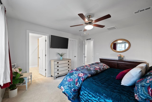 bedroom with ceiling fan, visible vents, and light colored carpet