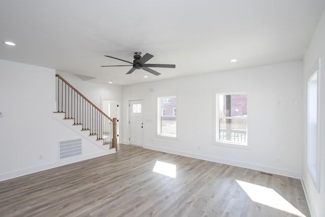 interior space featuring light wood finished floors, stairs, and recessed lighting