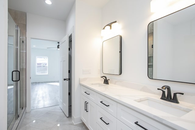 bathroom with double vanity, a sink, and a shower stall