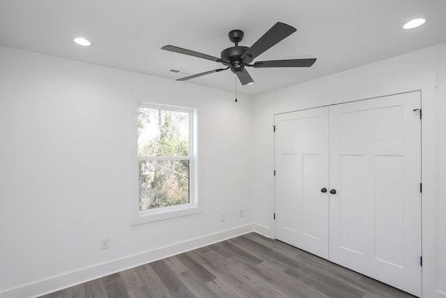 unfurnished bedroom featuring recessed lighting, a closet, a ceiling fan, wood finished floors, and baseboards