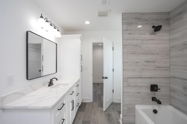 bathroom with recessed lighting, visible vents, vanity, and wood finished floors