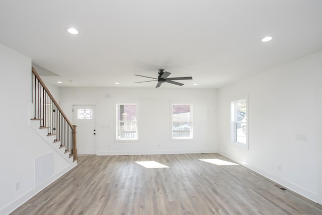 unfurnished living room featuring light wood-style floors, recessed lighting, and baseboards