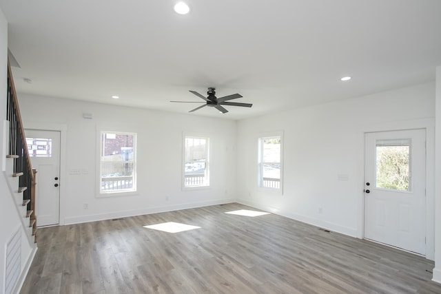 entryway featuring stairway, plenty of natural light, wood finished floors, and recessed lighting