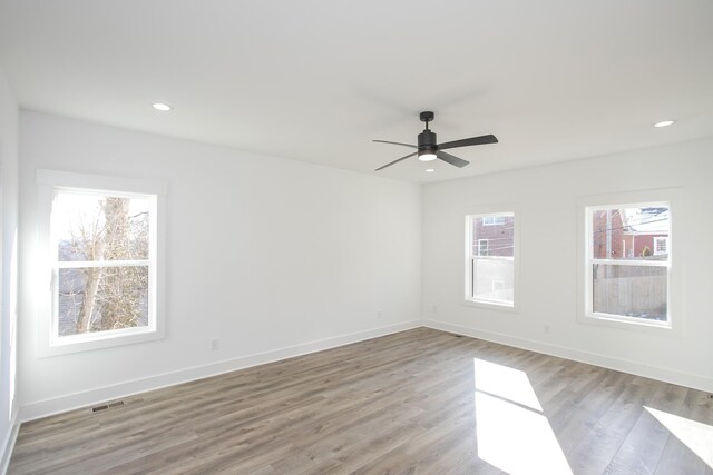 spare room featuring visible vents, recessed lighting, light wood-style flooring, and baseboards