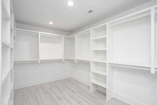 spacious closet featuring visible vents and wood finished floors