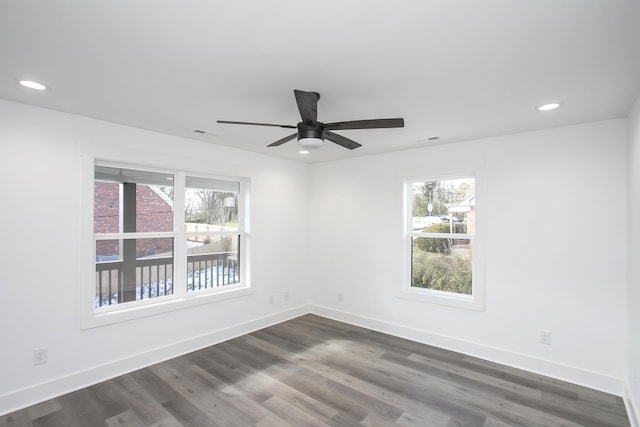 spare room with recessed lighting, dark wood-style flooring, and baseboards