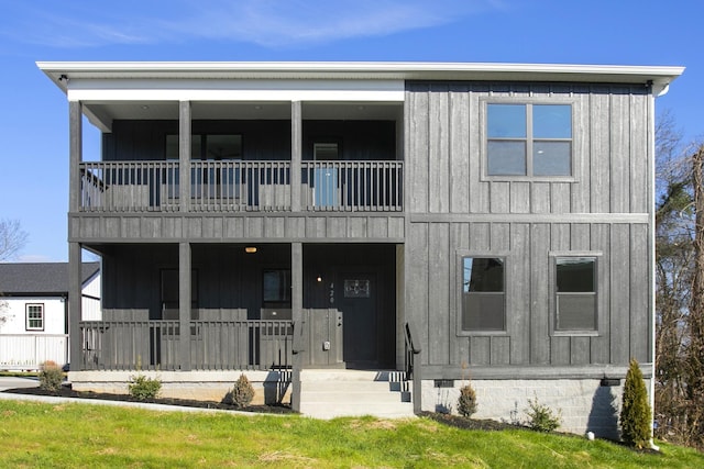 view of front of property featuring crawl space, covered porch, a balcony, and board and batten siding