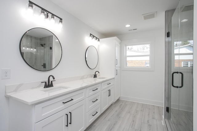 full bath with a stall shower, visible vents, and a sink