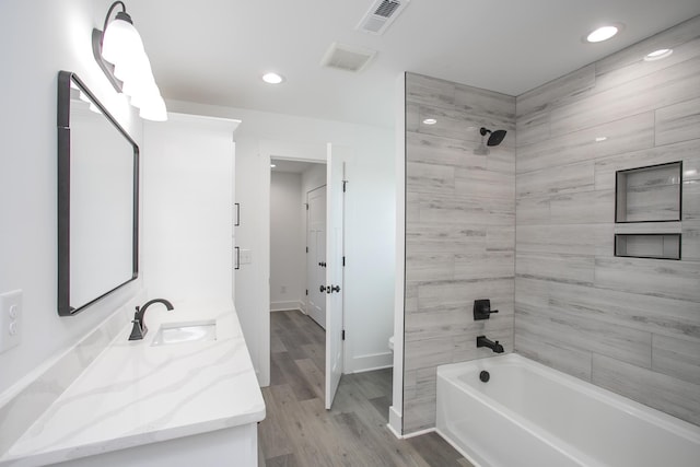 full bathroom with visible vents, vanity, toilet, and wood finished floors