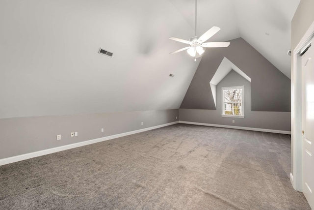 bonus room featuring lofted ceiling, carpet floors, visible vents, and baseboards