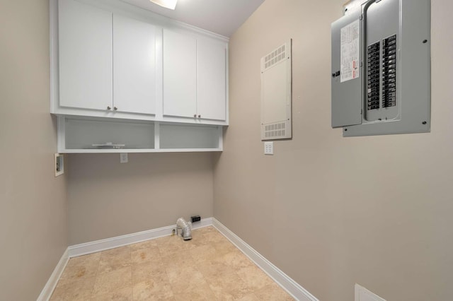 laundry area featuring hookup for a washing machine, electric panel, cabinet space, and baseboards