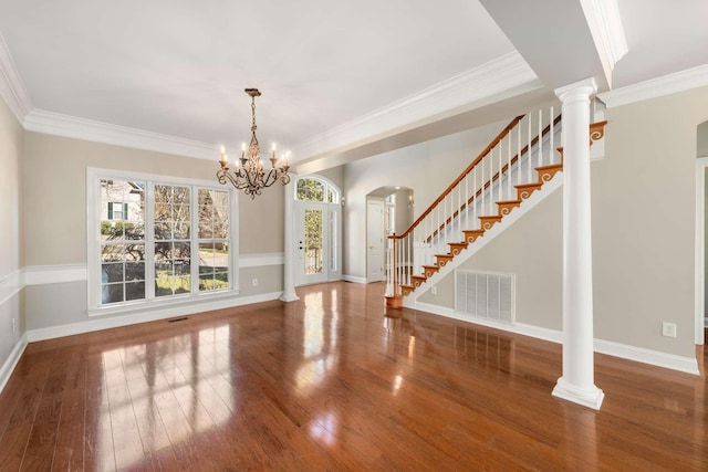 interior space with decorative columns, crown molding, visible vents, and hardwood / wood-style floors