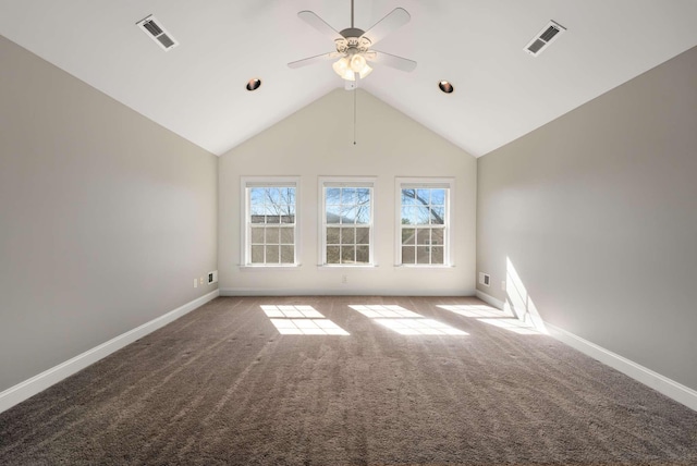 carpeted empty room with lofted ceiling, baseboards, visible vents, and a ceiling fan