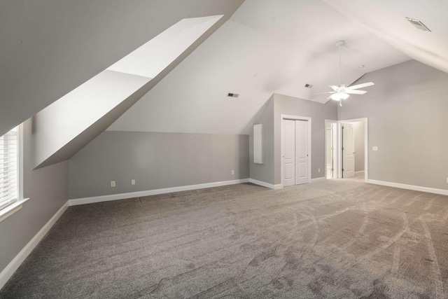 additional living space with lofted ceiling, carpet, visible vents, and baseboards