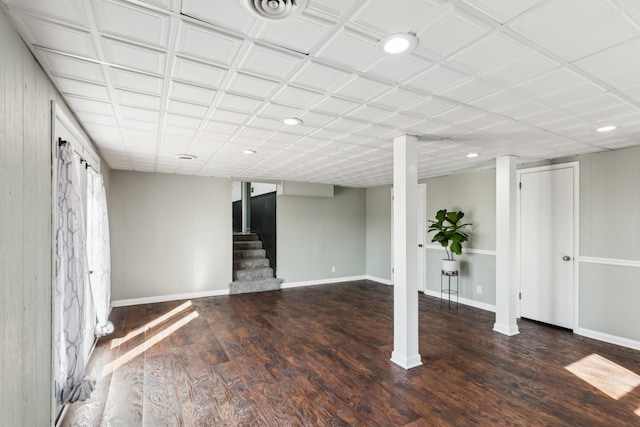 finished basement with visible vents, baseboards, wood finished floors, stairs, and recessed lighting