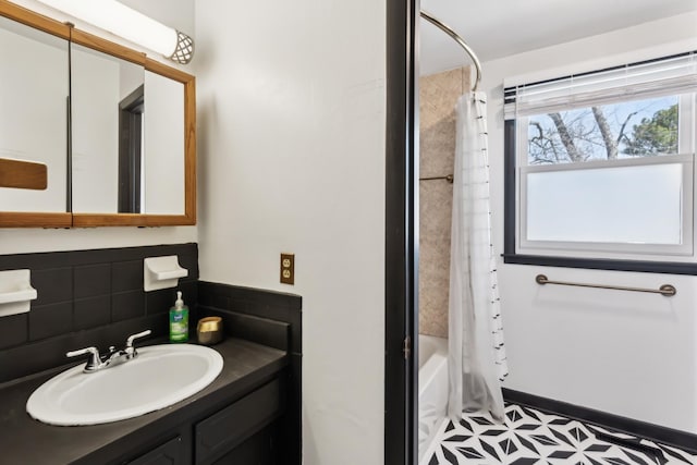 full bath featuring shower / bath combo, tile patterned floors, vanity, and decorative backsplash