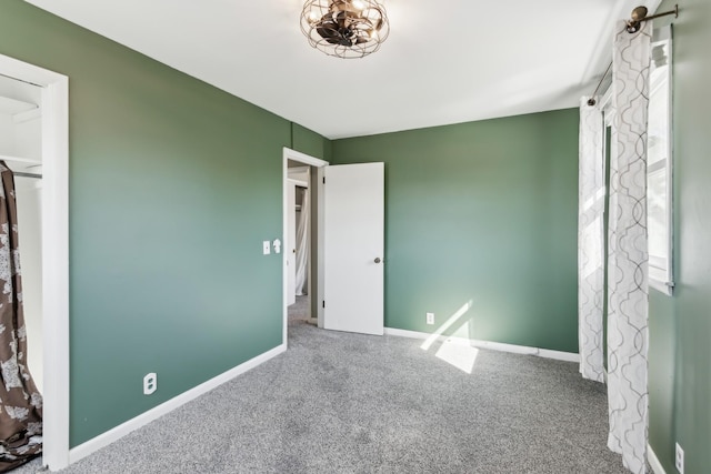 unfurnished bedroom featuring carpet and baseboards