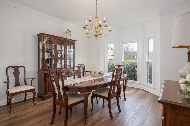 dining room with crown molding, a notable chandelier, dark wood finished floors, and baseboards