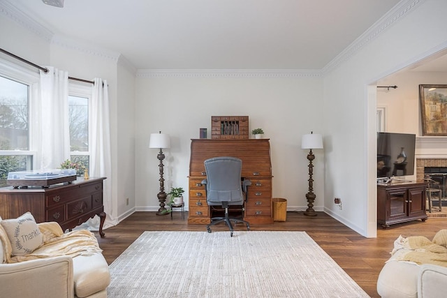 office space featuring a brick fireplace, wood finished floors, and baseboards