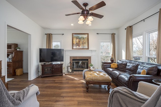 living area featuring ceiling fan, recessed lighting, a fireplace, wood finished floors, and baseboards