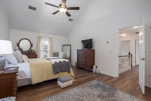 bedroom with high vaulted ceiling, visible vents, baseboards, and wood finished floors