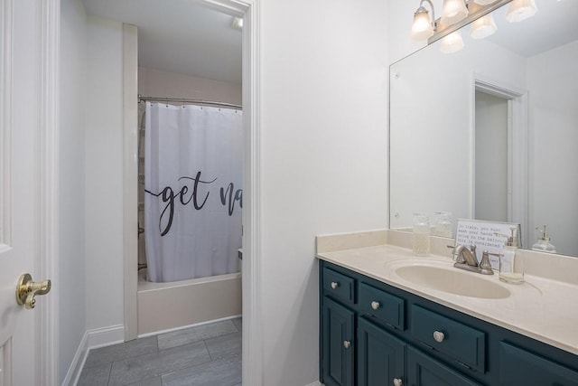 full bathroom featuring shower / tub combo, vanity, and baseboards