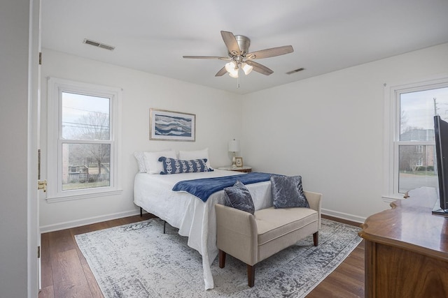 bedroom with a ceiling fan, baseboards, visible vents, and dark wood-style flooring