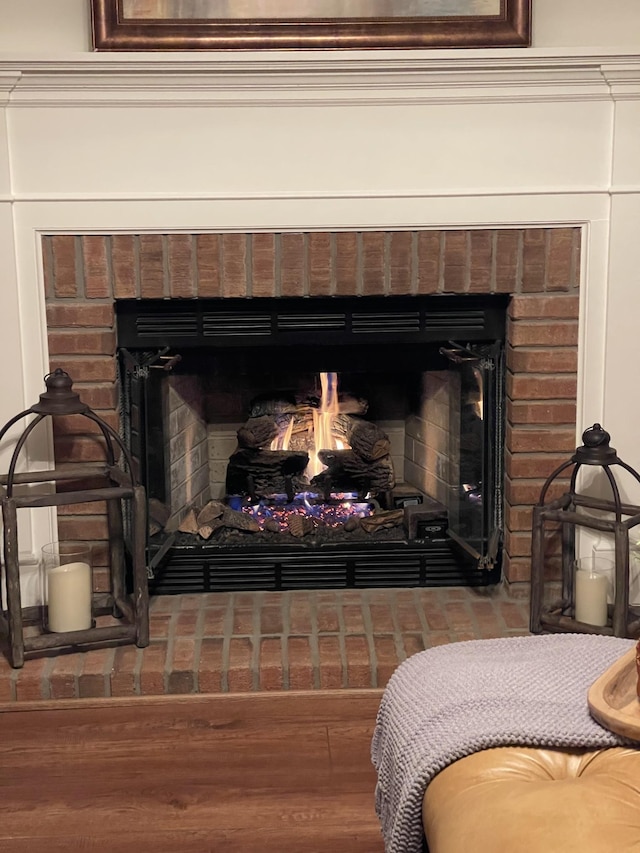 interior details with a fireplace and wood finished floors