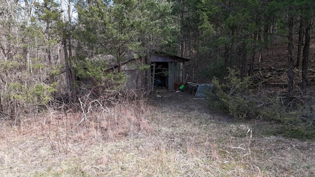 exterior space featuring an outbuilding and a forest view