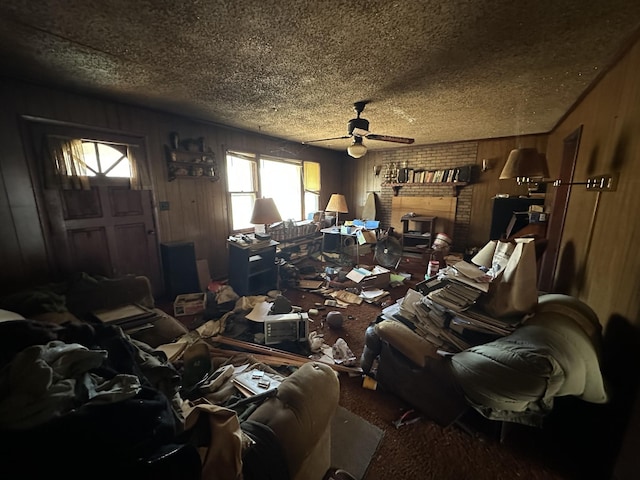 interior space featuring wood walls, ceiling fan, and a textured ceiling