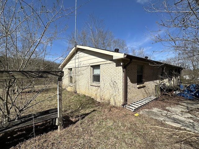 view of side of property with brick siding